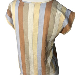 May include: A striped short-sleeved top with a scoop neck. The stripes are in shades of brown, beige, and light blue.