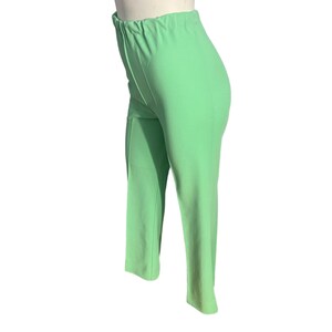 May include: Light green pants with an elastic waistband. The pants are a solid color and have a straight leg design. The fabric appears to be a lightweight material, suitable for warmer weather.