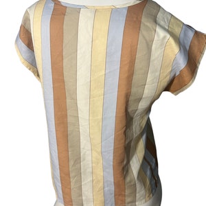 May include: A striped short-sleeved top with a scoop neck. The stripes are in shades of brown, beige, and blue.