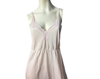 May include: A pink slip dress with a lace trim around the neckline.
