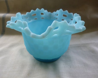 May include: A light blue glass bowl with a lacy, openwork rim. The bowl is made of frosted glass and has a delicate, feminine design.