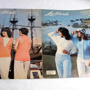 May include: Two pages from a vintage knitting pattern book featuring LeeWards. The left page shows two women wearing knitted sweaters in orange and white. The right page shows two women wearing knitted sweaters in blue and white. The women are standing in front of a ship on the left page and a beach scene on the right page.