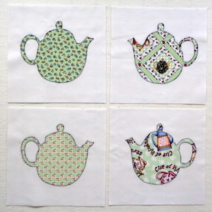 May include: Four fabric squares with appliqued teapot designs. Each teapot is a different pattern, including floral, geometric, and text. The teapots are outlined with a dark green stitch on a white background, perfect for quilting or crafting projects.
