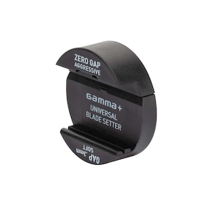 Pode incluir: Um ajustador de lâmina universal Gamma+ preto com o texto "ZERO GAP AGGRESSIVE" e "UNIVERSAL BLADE SETTER". A ferramenta tem um design curvo e inclui o texto "GAP .3mm SOFT".