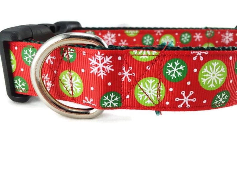 May include: Red dog collar with a green and white snowflake pattern.
