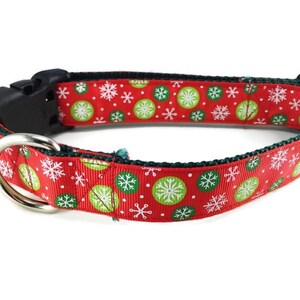 May include: Red dog collar with a green and white snowflake pattern.