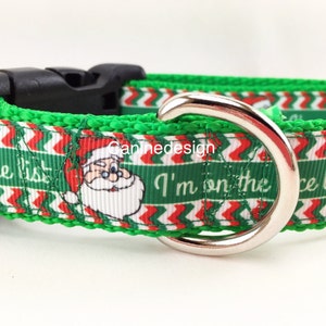 May include: Green, red, and white dog collar with a chevron pattern and a Santa Claus image. The collar has the text "I'm on the nice list" on it.