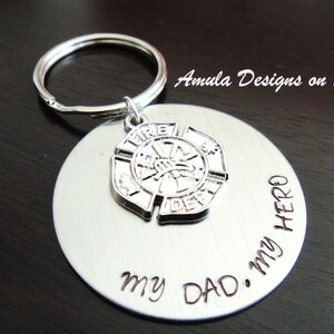 May include: Silver keychain with a firefighter emblem and the words "My Dad. My Hero." engraved on a round tag.
