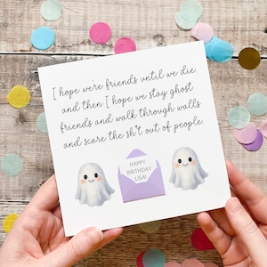 May include: A white birthday card with a handwritten message and ghost illustrations. The card features the text "I hope we're friends until we die..." and "Happy Birthday Lisa!" in a purple envelope. Confetti surrounds the card.