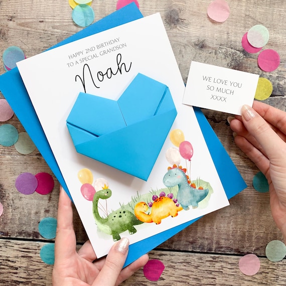 A birthday card that folds into a 3D origami heart the kid gets to keep — the card IS the gift, with a clever dinosaur twist.