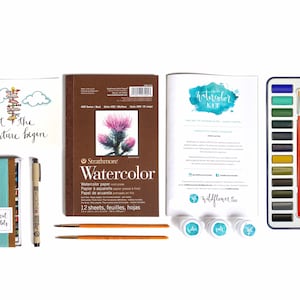 May include: Watercolor art supplies kit with a watercolor pad, paint set, brushes, and a card that says "Let the adventure begin".