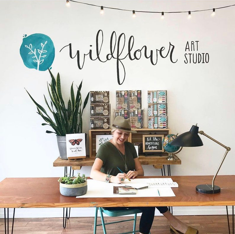 Hand Lettering Instructor seated, working on Hand Lettering projects
