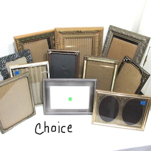 May include: A collection of assorted picture frames in various shapes, sizes, and colors. Frames include gold, silver, and black, with ornate and simple designs. The word "Choice" is written in black script at the bottom.