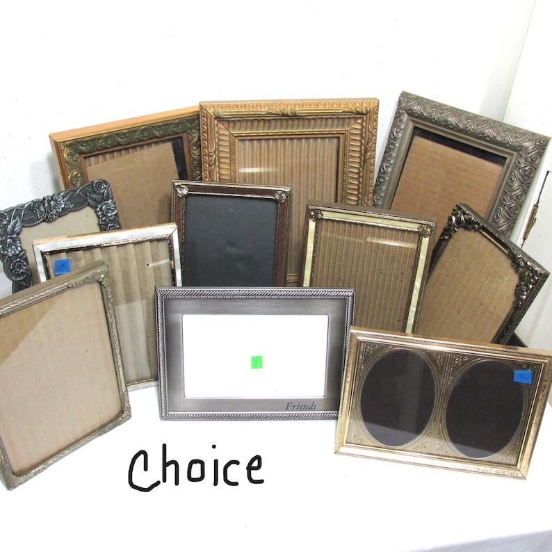 May include: A collection of assorted picture frames in various shapes, sizes, and colors. Frames include gold, silver, and black, with ornate and simple designs. The word "Choice" is written in black script at the bottom.