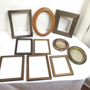 May include: A collection of nine picture frames in various styles and sizes. The frames are made of wood, metal, and glass. Some of the frames are ornate, while others are simple. The frames are all in good condition and would be a great addition to any home.