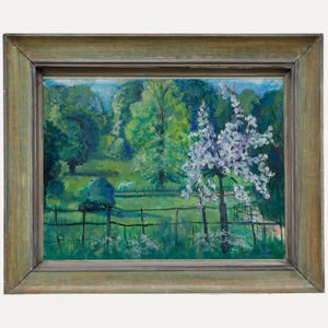 May include: Oil painting depicting a tranquil landscape with a wooden fence, green grass, and trees. A tree with white blossoms is in the foreground. The painting is framed in a light green wooden frame.