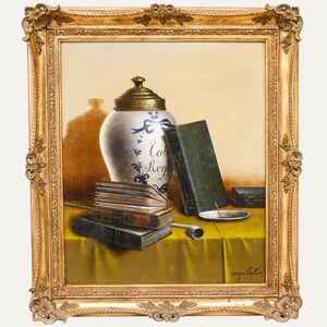 May include: An antique still life painting in a gold ornate frame. The painting depicts a white and blue jar with the text "Cal Roy", books, a pipe, and a small plate on a yellow tablecloth.