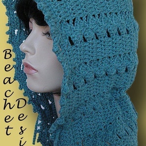 May include: Teal crochet hooded scarf with a lacy design. The scarf is worn on a mannequin.
