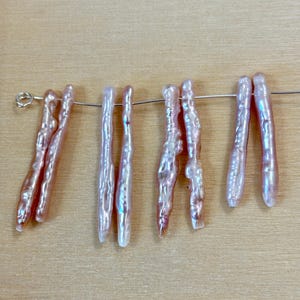 Match stick pearls soft mauve peach color sold by the pair, 2 pieces over 25mm each