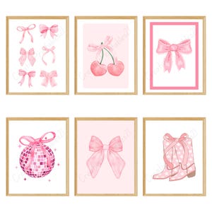 May include: Six framed art prints featuring watercolor illustrations. The prints showcase pink bows, cherries, a disco ball, and cowboy boots. The art has a feminine theme with a soft color palette and a touch of whimsy.