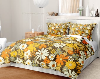 May include: A brown, white, and orange floral duvet cover with matching pillowcases. The duvet cover features a large-scale daisy pattern.