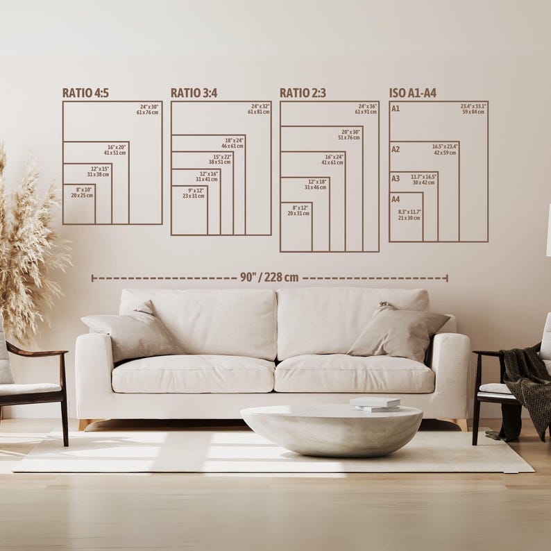May include: A wall art size guide featuring various aspect ratios and ISO A1-A4 sizes. The guide includes ratios like 4:5, 3:4, and 2:3, with dimensions in inches and centimeters. The text labels the sizes, and a horizontal line indicates a 90'/228 cm measurement. The guide is displayed above a cream-colored sofa.