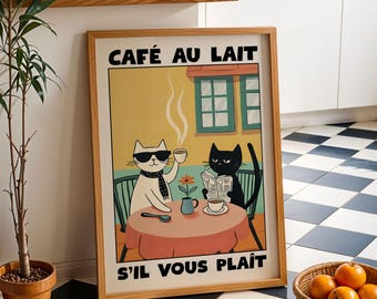May include: A framed art print with a cartoon illustration of two cats in a cafe setting. One cat, wearing sunglasses, holds a coffee cup, the other reads a newspaper. The print includes the text "CAFÉ AU LAIT" and "S'IL VOUS PLAÎT".