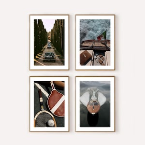 May include: Four framed art prints with gold frames. The images show a vintage car on a tree-lined road, a boat with an Italian flag, tennis equipment, and a speedboat on a lake.