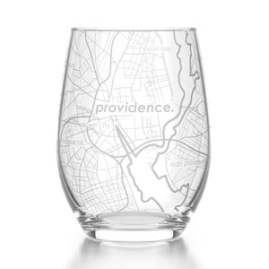 May include: A clear glass wine glass with an etched map of Providence, Rhode Island. The map includes the words "Providence", "East Side", "Down City", and "Federal Hill".