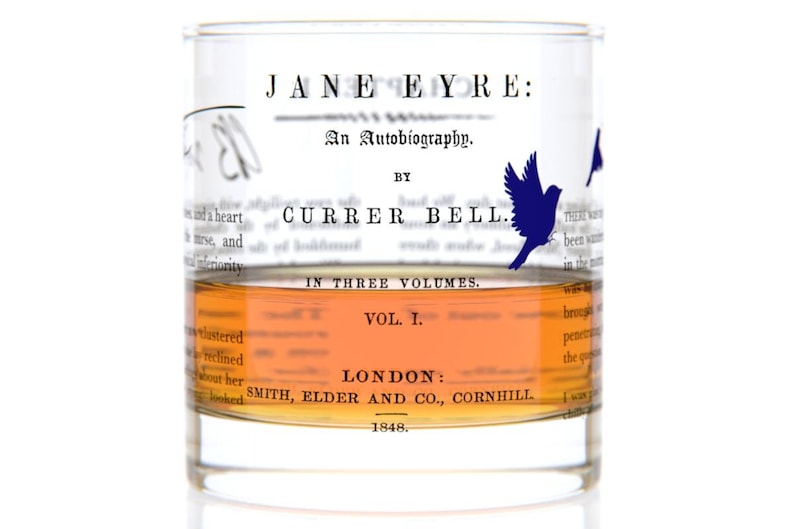 May include: A clear glass tumbler with a blue bird design and the text "JANE EYRE: An Autobiography. BY CURRER BELL. IN THREE VOLUMES. VOL. I. LONDON: SMITH, ELDER AND CO., CORNHILL 1848."