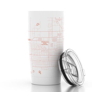 May include: White travel mug with a red outline map of the Oklahoma State University campus. The mug has a clear lid with a slider.
