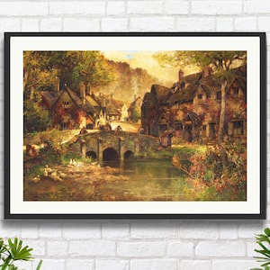 May include: Framed landscape art print depicting a quaint village scene. A stone bridge arches over a river, leading to buildings with thatched roofs. The artwork features warm, earthy tones, with lush greenery and a soft, diffused light.