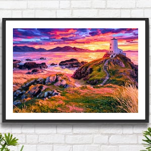 May include: A framed landscape painting shows a white lighthouse on a rocky outcrop at sunset. The sky is a vibrant blend of orange, pink, and purple. A stone path leads to the lighthouse. The foreground features colorful grasses and rocks, with the sea in the distance.