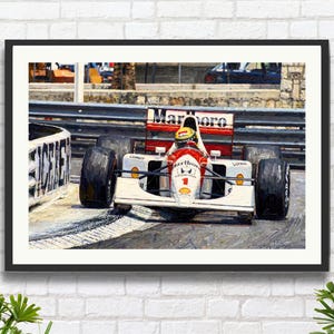May include: Framed artwork of a Formula 1 race car in action. The car is white and red, with the Marlboro logo prominently displayed. The driver is wearing a yellow helmet. The image is set against a backdrop of a race track.