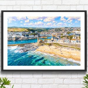 May include: A framed print of a coastal town with a beach, harbor, and buildings. The artwork features a vibrant color palette of blues, greens, and yellows, depicting the sea, sky, and townscape. The image is framed in a black border.