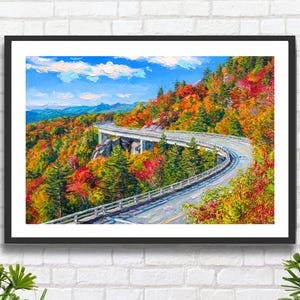 Könnte beinhalten: Ein gerahmtes Landschaftsgemälde, das eine geschwungene Betonbrücke zeigt, die sich im Herbst durch einen Bergwald schlängelt. Die Szene zeigt leuchtend rotes, oranges und gelbes Laub vor einem hellblauen Himmel mit weißen Wolken.