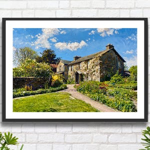 May include: A framed art print depicting a stone cottage with a pitched roof, surrounded by a lush garden with green foliage and colorful flowers. A stone path leads to the entrance under a bright blue sky with white clouds, rendered in an oil painting style.