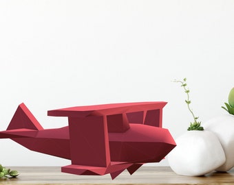 May include: A red origami-style aeroplane sculpture on a wooden surface. The aeroplane has a geometric design and is made of paper.