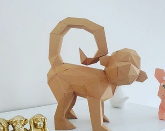 May include: A geometric paper monkey sculpture in shades of brown. The monkey has a curled tail and is standing on all fours. The sculpture is made of folded paper and has a polygonal design. Other decorative items are in the background.