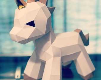 May include: A white origami unicorn with a gold horn and brown accents. The unicorn is standing on a dark surface.