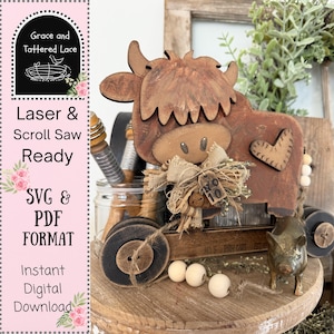 May include: A rustic wooden cow figurine with a heart detail, part of a decorative display. The cow is brown with a distressed finish, and is attached to a small cart. The image includes the text "Grace and Tattered Lace", "Laser & Scroll Saw Ready", "SVG & PDF FORMAT", and "Instant Digital Download".