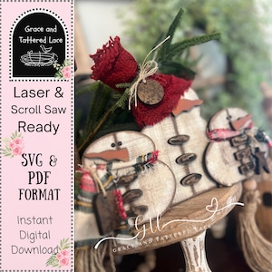 May include: Wooden snowman decorations with red scarves and button details. The ornaments are displayed on a decorative wooden stand. The image also includes text that says "Laser & Scroll Saw Ready" and "SVG & PDF FORMAT".