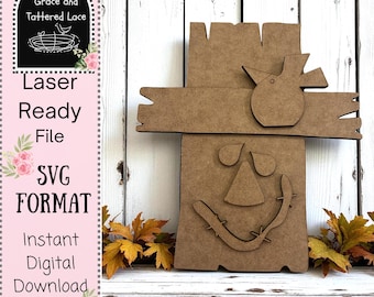 May include: A brown wooden scarecrow-shaped laser-ready file. The design includes a bird, a triangle nose, and a stitched mouth. The text "Laser Ready File SVG FORMAT Instant Digital Download" is on the left side.