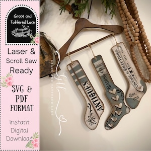 May include: Wooden decorative stocking ornaments with distressed paint finish. The ornaments are hung from a wooden hanger and feature the words "Antiques", "Trading Co", and "Vintage & Collectibles". The ornaments are in a SVG & PDF format.
