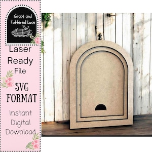 May include: A light brown, unfinished wooden arch-shaped cutout with a recessed interior and a semi-circular opening at the bottom. The cutout is leaning against a white wooden wall. Text on the left side reads "Laser Ready File SVG Format Instant Digital Download."