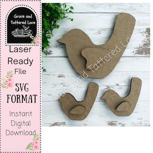 May include: Three wooden bird cutouts, one large bird and two smaller birds. The birds are all brown and have a simple design. The text "Grace and Tattered Lace" is visible in the background.
