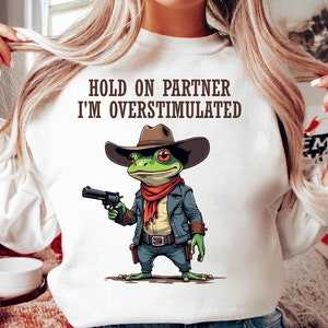 Hold On Partner I'm Overstimulated SVG PNG,  Cowboy Frog Funny Quote svg file shirt , Trending Frog Humor Png design download