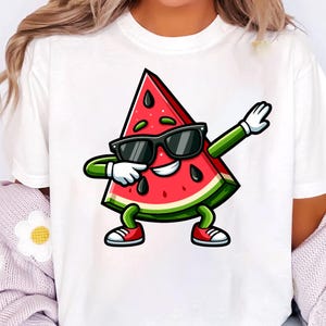 May include: White t-shirt with a cartoon watermelon slice wearing sunglasses and red trainers, dabbing with its arms. The watermelon has a red interior with black seeds and a green rind.