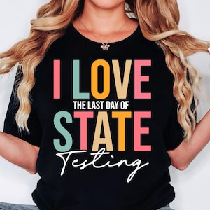 May include: Black t-shirt with the text "I LOVE THE LAST DAY OF STATE TESTING" in colourful block letters.