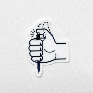 May include: A white sticker with a black outline of a hand holding a spray bottle. The hand is depicted with a black outline, and the spray bottle is black. Arrows indicate the action of spraying.